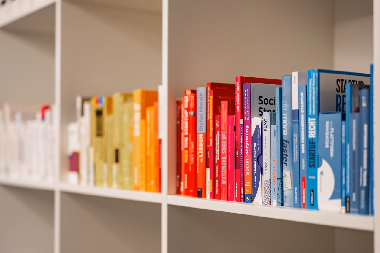 Bunte Bücher in einem weißen Regal
